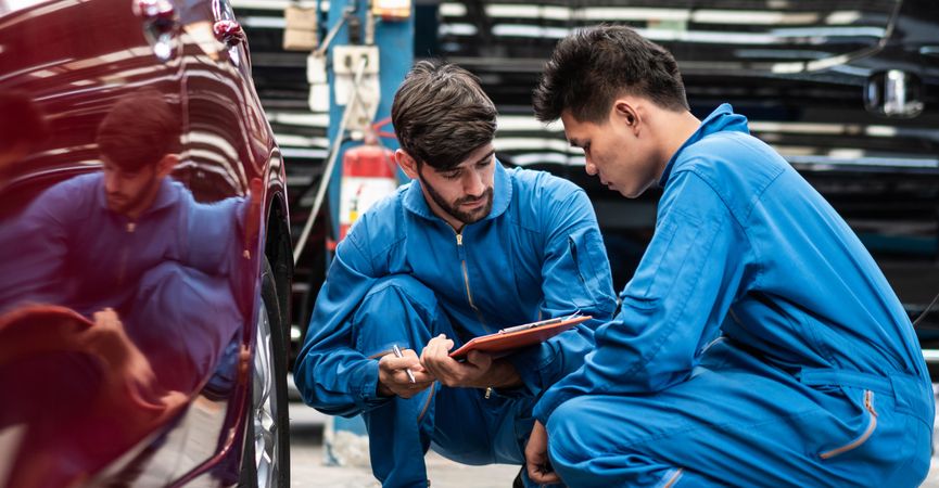 Mechanic men checking car tire condition