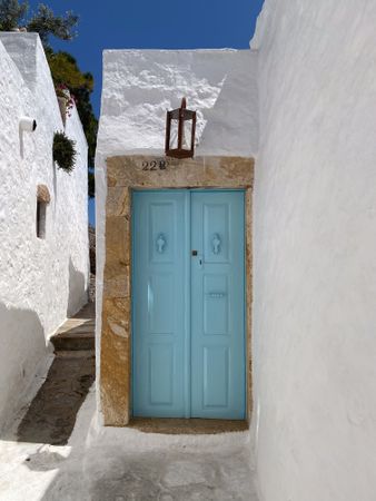 Patmian blue door by street steps to monastery