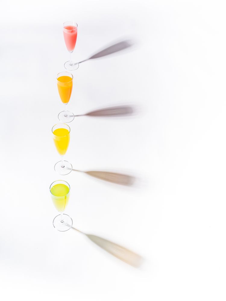 Glasses of bright colorful drinks on table