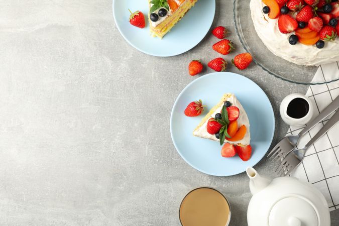 Composition with delicious berry cream cake on gray background. Tasty dessert