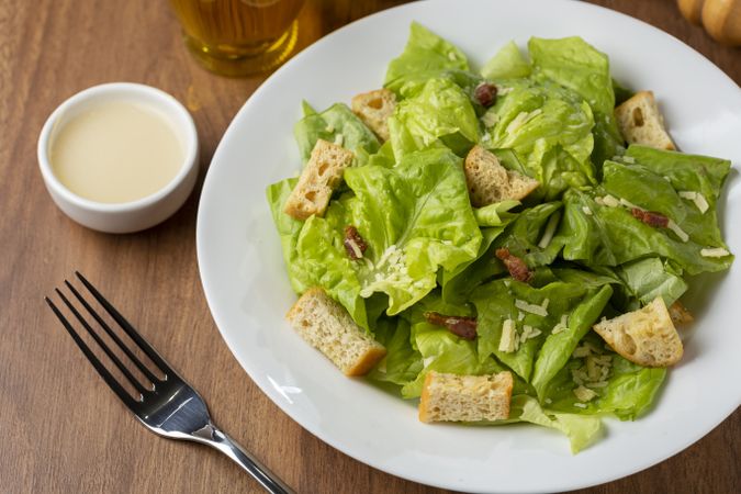 Caesar salad with croutons and bacon.