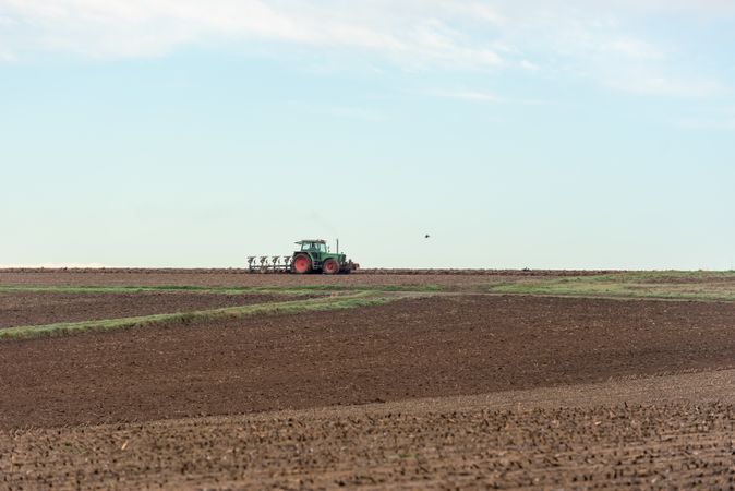 Tractor plowing agricultural fields outside of Stuttgart city, Germany