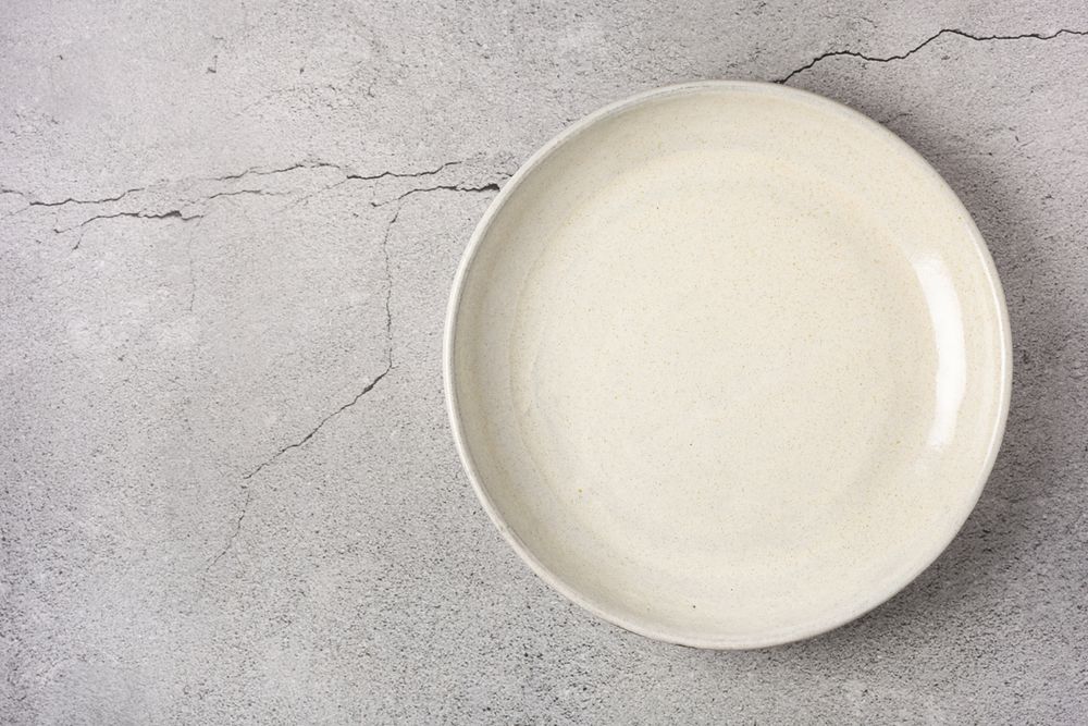 Empty plate on the slate table. Top view of the image.