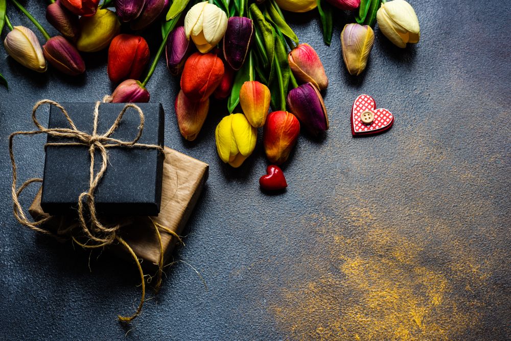 Red bag of tulips with present and heart ornaments