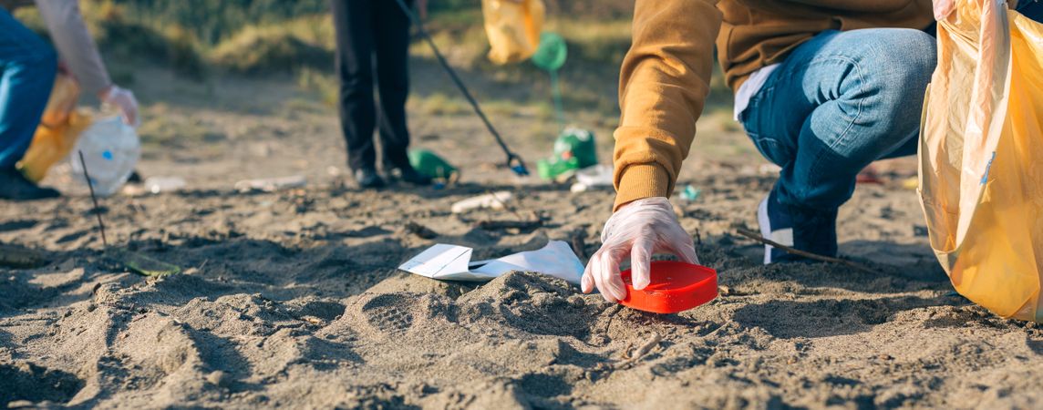 Young man cleaning the beach