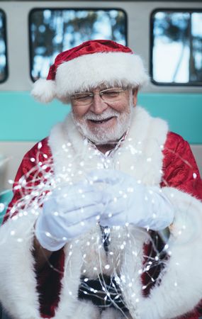 Santa Claus sitting with gifts and garland