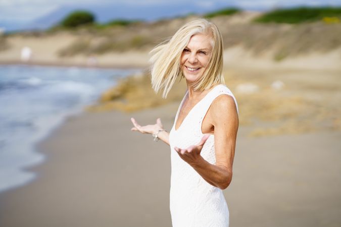Content mature woman with her arms making questioning gesture