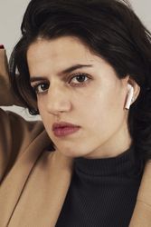 Woman with earbuds in studio