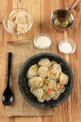 Bowl of stir fried Indonesian noodles with other raw ingredients