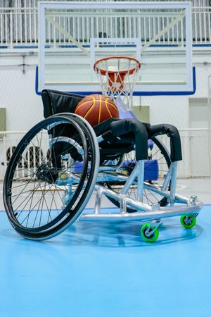 Basketball on wheelchair in an indoor basketball field