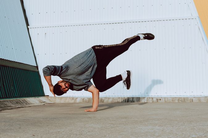 Man performing handstand near wall