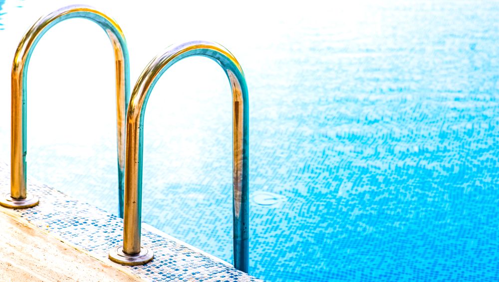 Golden pool railing in the sun