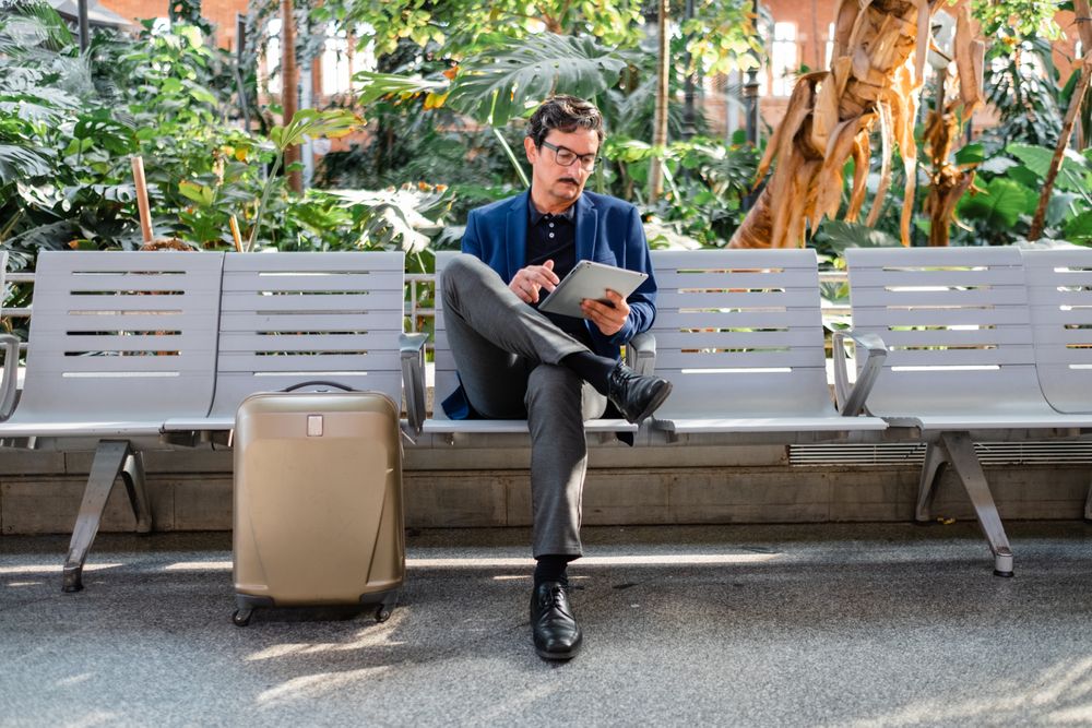 Older handsome man using digital tablet outdoors