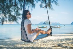 Woman in hammock near sea