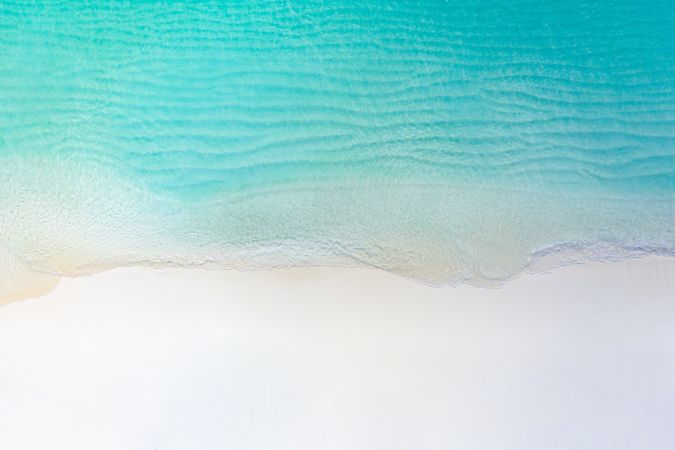 Aerial shot of clear water at a tropical, idyllic beach