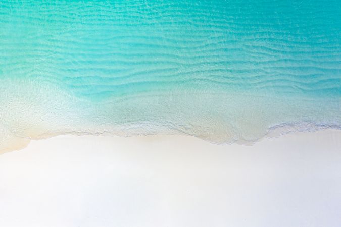 Aerial shot of clear water at a tropical, idyllic beach