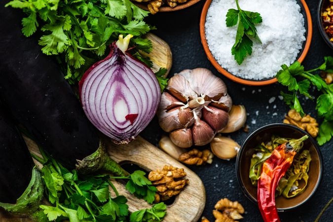 Top view of ingredients for cooking eggplant dish on rustic background