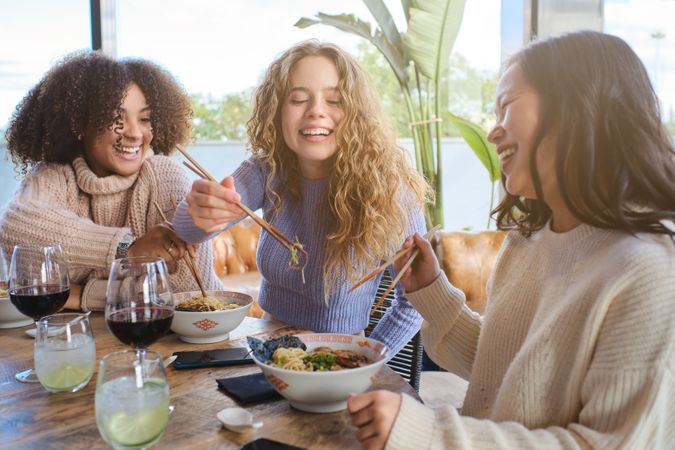 Group of diverse women having lunch in cafe