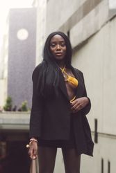 London, England, United Kingdom - September 18 2021: Woman in blazer with orange bikini