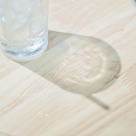 Clear drinking glass on brown wooden table