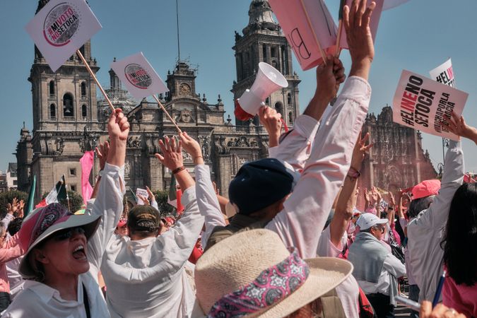 Mexico City, Mexico - February 26th, 2022: Group of enthusiastic protesting with their arms up