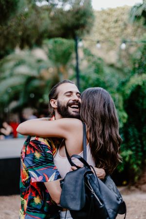 Embracing couple on street laughing