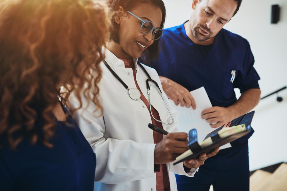 Group of doctors and nurses taking notes