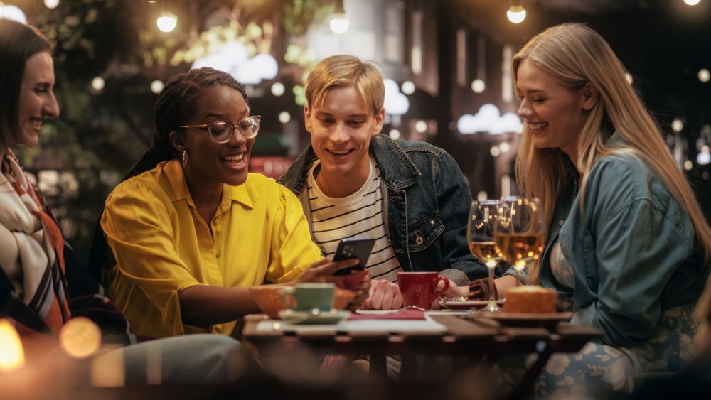 Young Friends Having Fun Conversations Together in a Cafe.