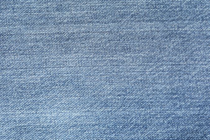 Texture of blue jeans as background, space for text