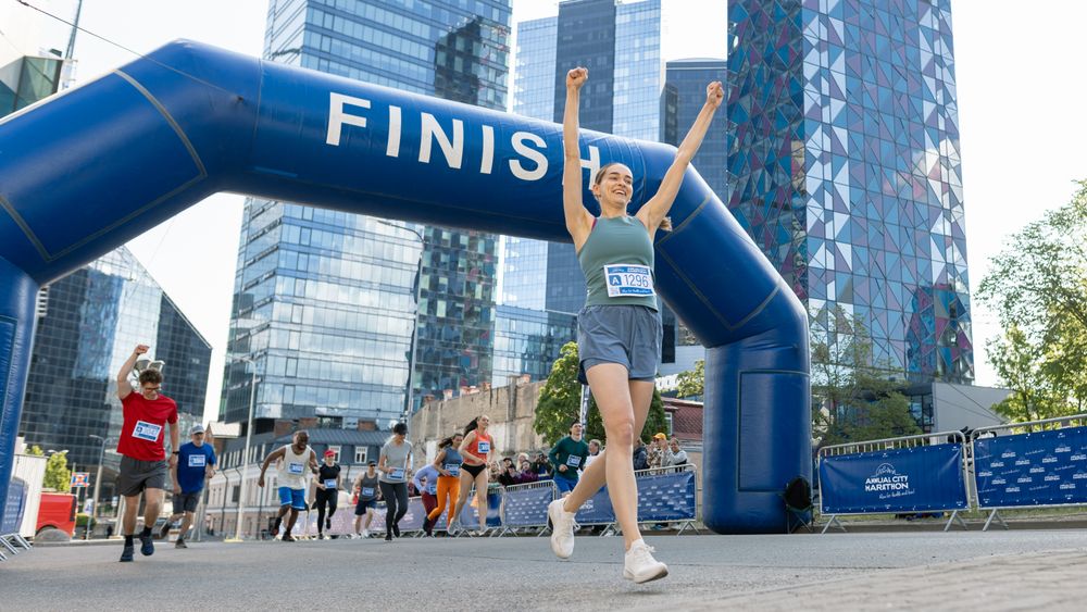 Portrait of Happy Female Runner Participating in a Marathon.