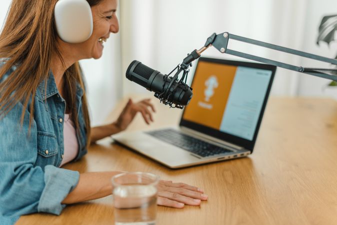 Woman in headphones recording podcast