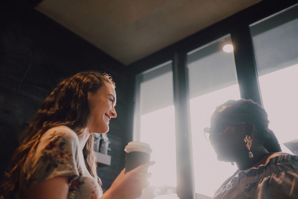 Multiethnic modern women relaxing at coffee shop