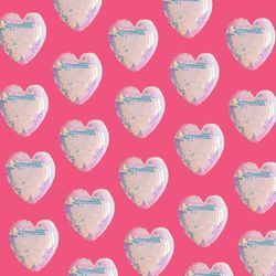 Iridescent sequins heart pattern on bright pink background