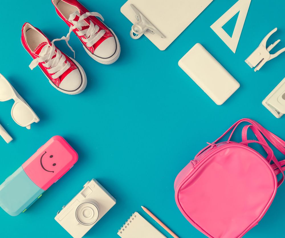 Back to school supplies on bright blue background