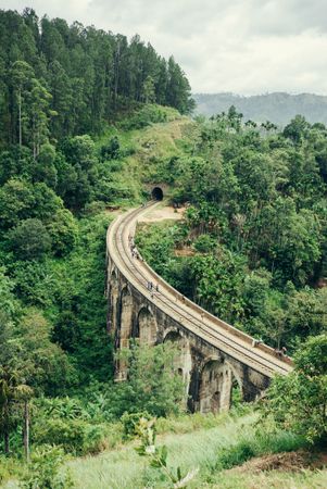 Looking down at people on rail tracks going through Sri Lankan forest