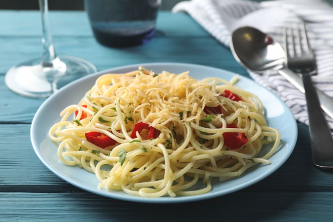 Composition with plate of tasty pasta on wooden background