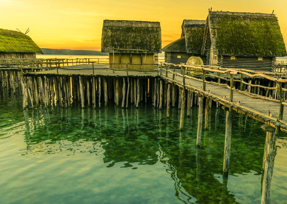 Fishing huts suspended on pillars at sunset