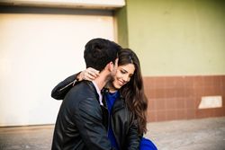 Amorous couple hugging on the street