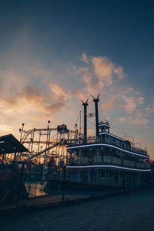 Tourist ship and roller coaster in entertainment park