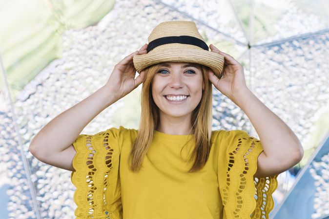 Stylish woman posing in straw hat