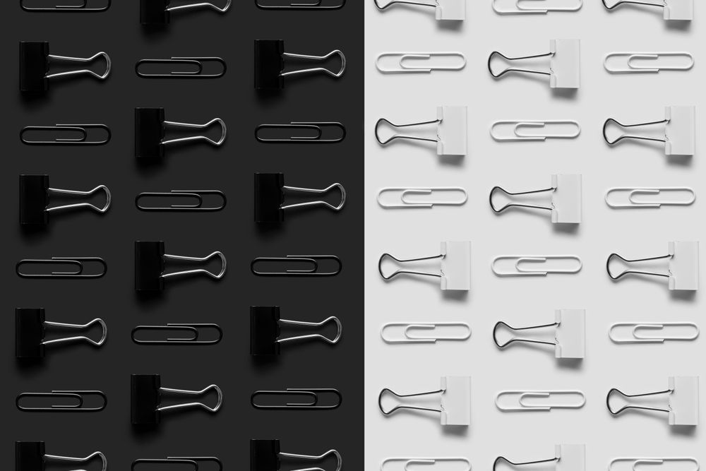 Paper clips and bider clips on monochrome background
