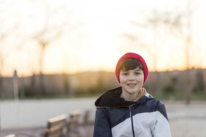 Young teenager portrait at sunrise in park with copy space