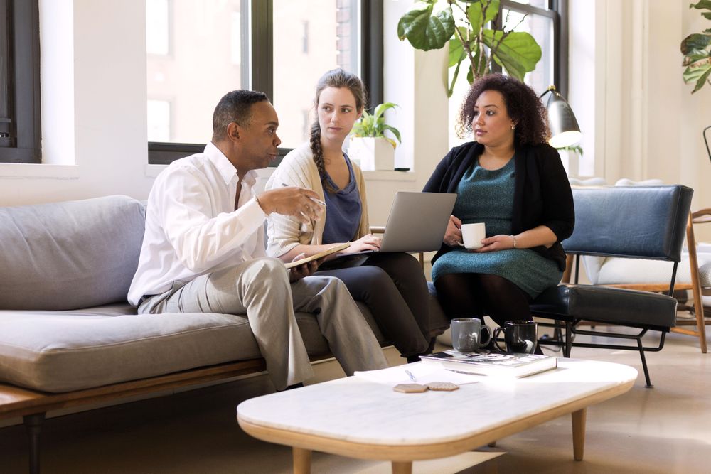 Man and two women having a business meeting