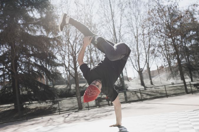 Man dancing break dance in park