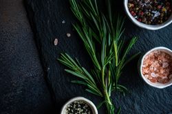 Top view of rosemary sprig with seasoning