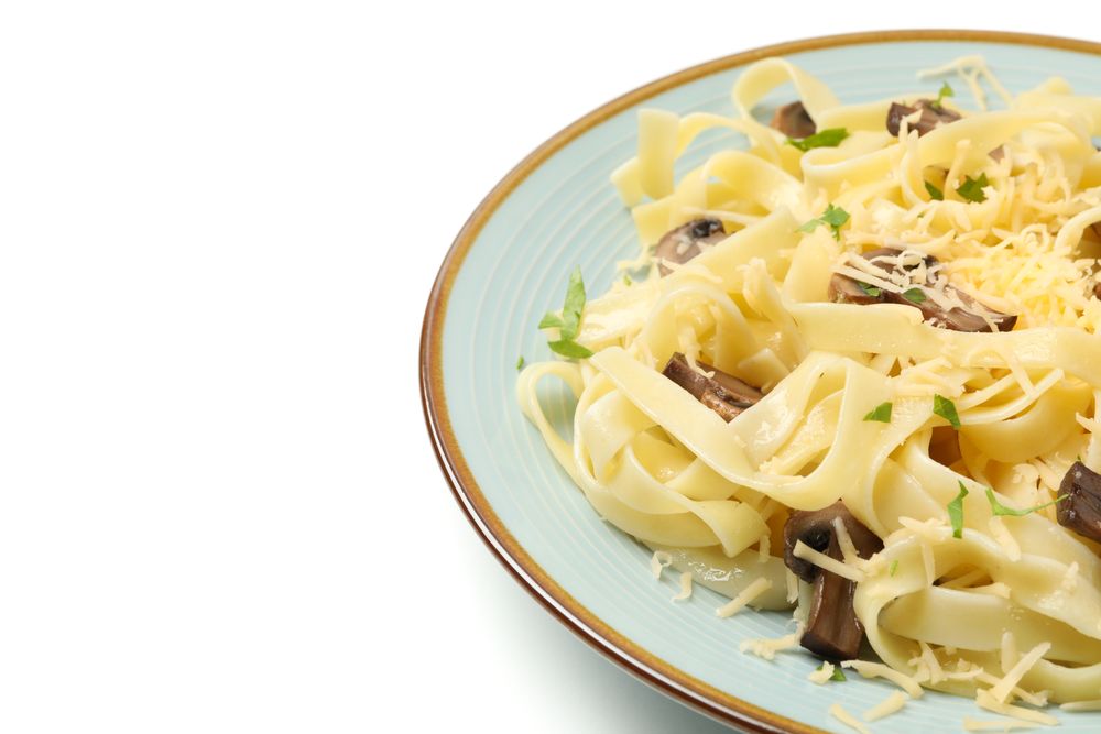 Plate with pasta, cheese and mushrooms isolated on plain background