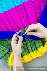Woman knitting colorful sweater 0VLYO4