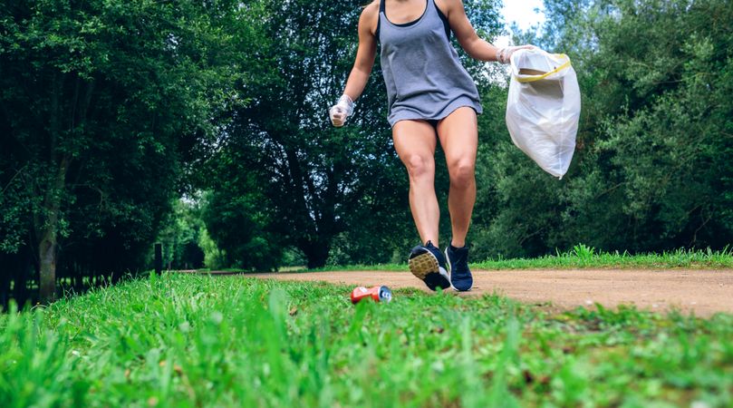 Woman with garbage bag doing plogging