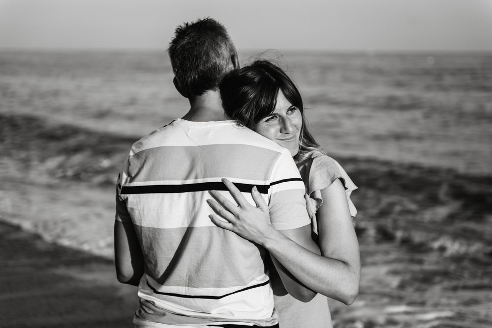 Adult couple embracing near sea