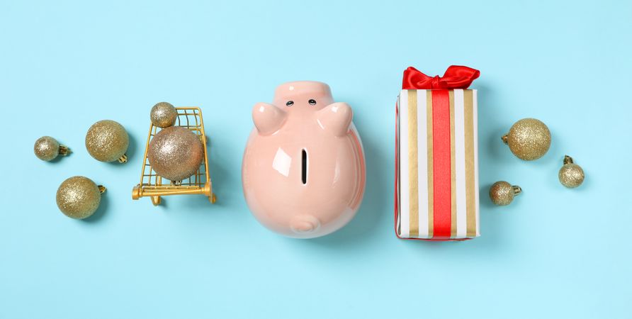Concept of Christmas finance with piggy bank, top view